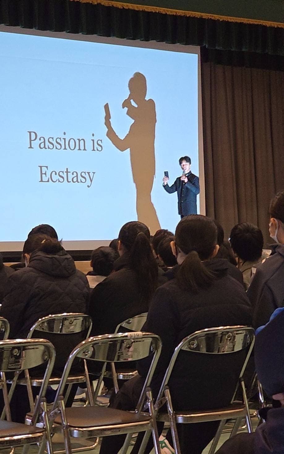 A founder presenting the slide that named the lab: Passion is Ecstasy.